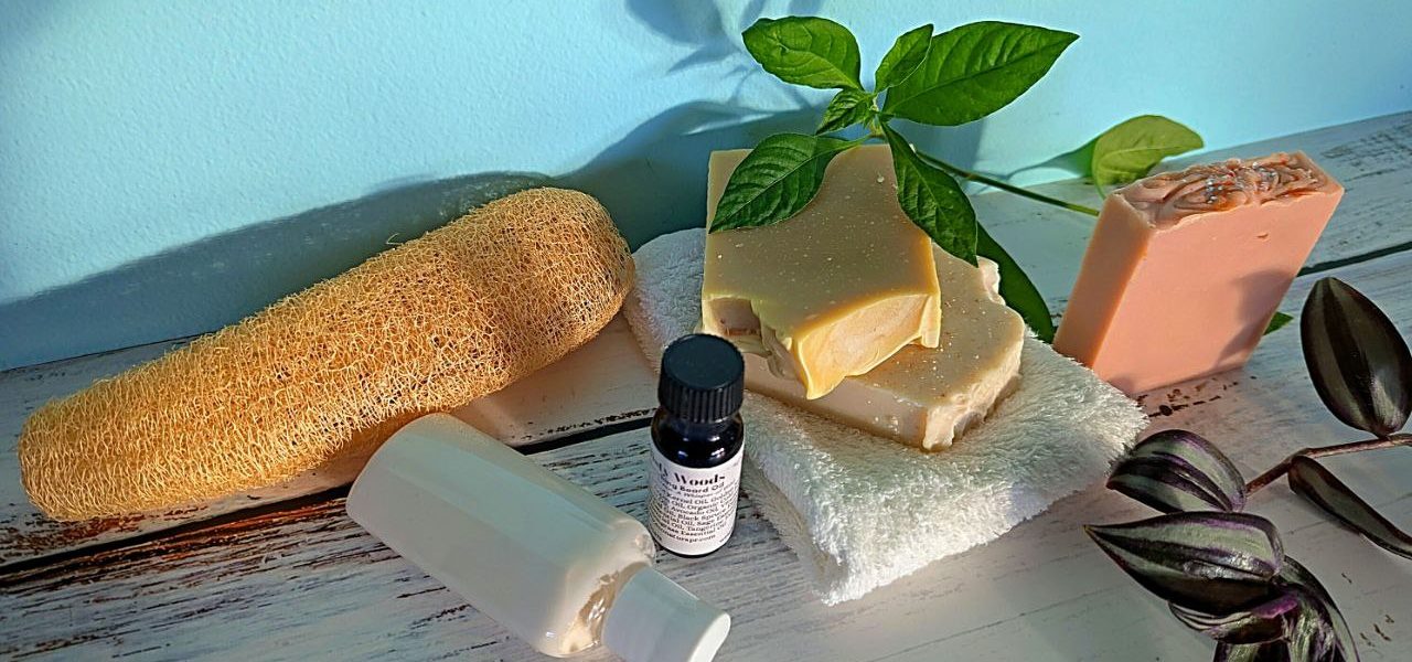 Assortment of natural bath products including sponges, soaps, and essential oils.